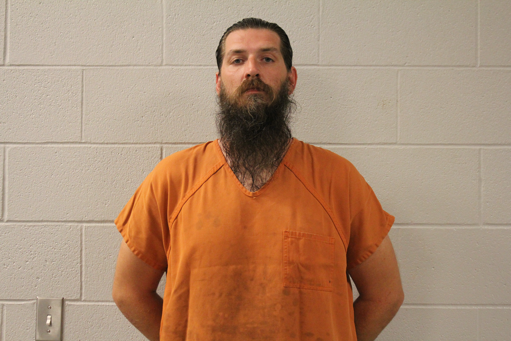 Inmate Garrett Morrell in orange top.